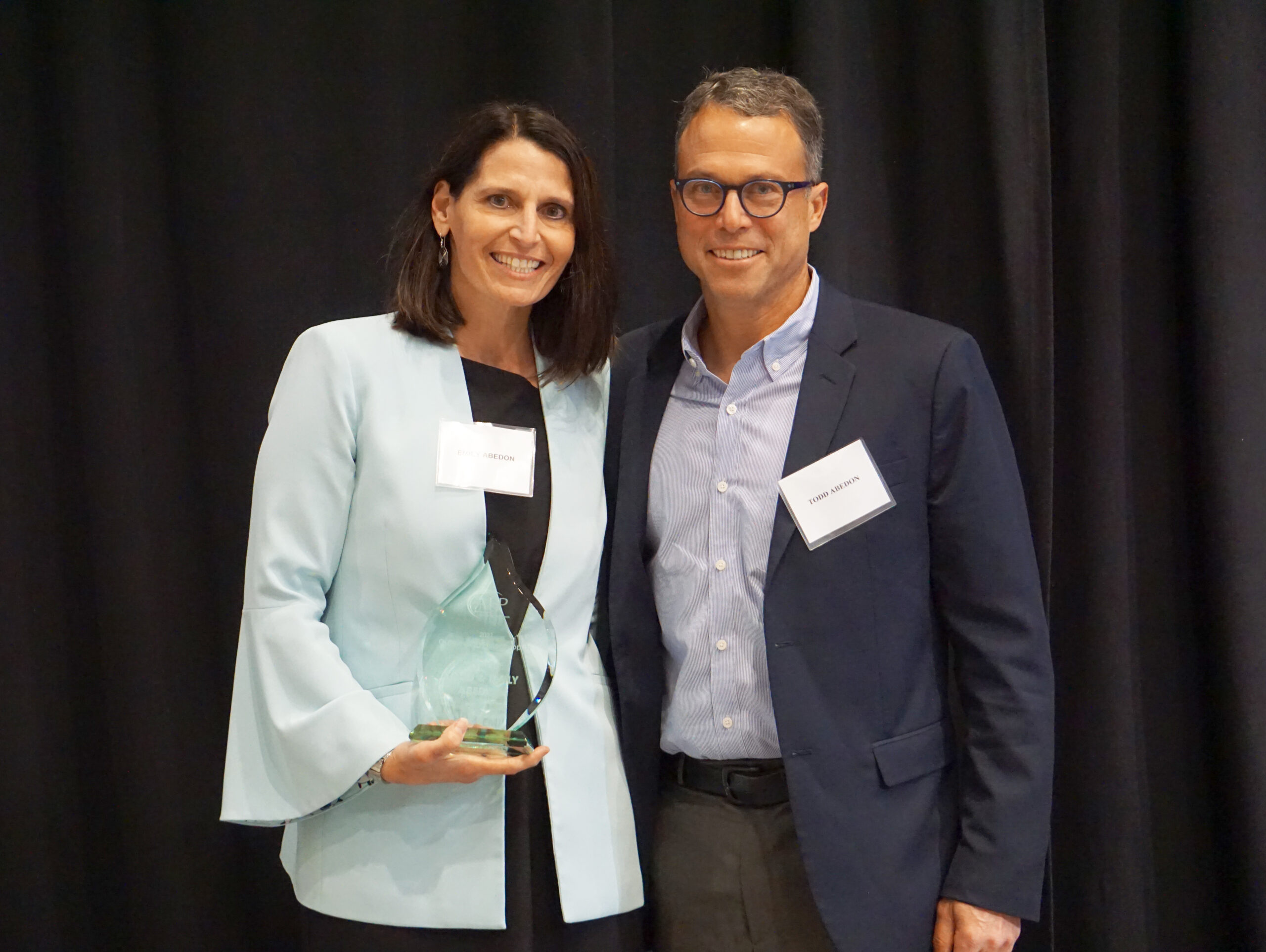 National Philanthropy Day winner's Tom and Emily stand with their award