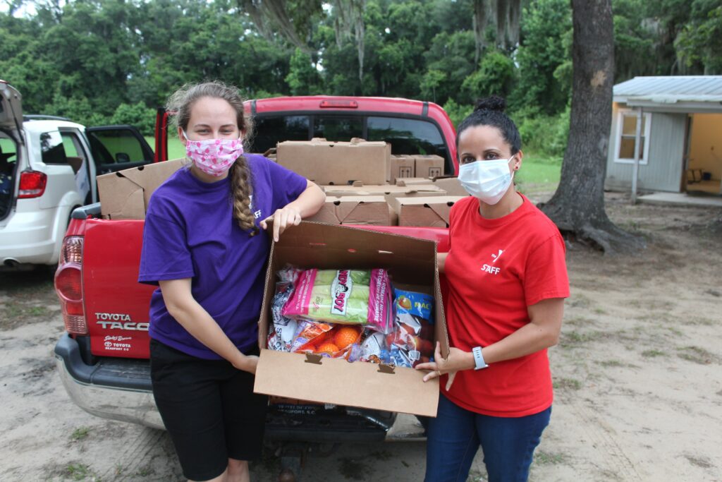 Beaufort-Jasper YMCA of the Lowcountry, a grantee of the COVID-19 Relief & Recovery Fund, employees hold donated food for their food distribution programs for families in need.